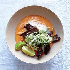 a bowl filled with meat and vegetables on top of a table