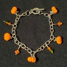 3D metal pumpkin charm bracelet with coordinating colored crystals  Matching earrings available Silver Dangle Jewelry With Removable Charms, Halloween Hypoallergenic Metal Jewelry, Orange Adjustable Costume Jewelry, Adjustable Orange Costume Jewelry, Halloween Handmade Metal Jewelry, Handmade Metal Jewelry For Halloween, Halloween Gold Dangle Jewelry, Gold Dangle Halloween Jewelry, Adjustable Metal Jewelry With Removable Charms