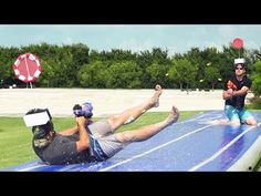 two men are playing on an inflatable water slide