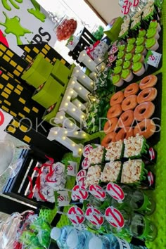 a table filled with lots of different types of food and candys on display for sale