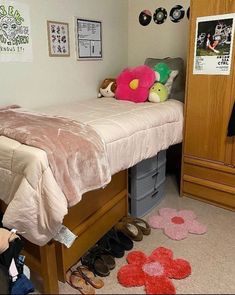 a bedroom with a bed, dresser and shoes on the floor