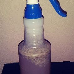 a blue and white hair dryer sitting on top of a bottle