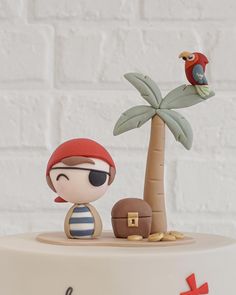 a cake with a pirate and parrot on top