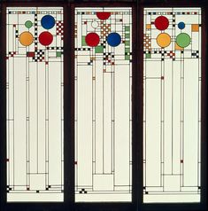 three stained glass windows with geometric designs on them