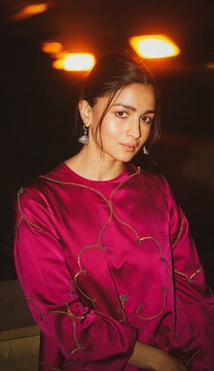 a woman in a red dress posing for a photo