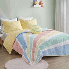 a child's bedroom with pastel colors and pillows on the bed, along with a teddy bear