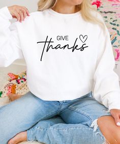 Give Thanks sweater - your perfect companion for cooler days! Celebrate the season of gratitude with our adorable "Give Thanks" sweater! This sweater is not only a fashion statement, but also a warm hug on chilly fall days. Made from high-quality, soft fabric, the sweater nestles gently against your skin and ensures that you feel completely comfortable - whether you're celebrating with friends or spending a cozy evening at home. The lovely design with the words "Give thanks" and a subtle heart s Season Of Gratitude, Thanksgiving Sweater, Thanksgiving Sweatshirt, Cozy Evening, Fall Clothing, Fall Days, Thanksgiving Gift, Warm Hug, Adulting Shirts