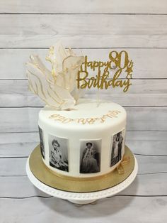 a white and gold birthday cake with photos on it