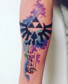 the legend of zelda watercolor tattoo on the left forearm and right arm, with music notes around it