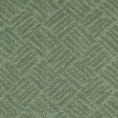 a close up view of a green carpet with an interesting pattern on the side and bottom