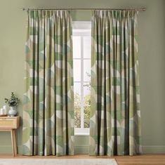 a living room with green curtains and a white rug in front of the window that has an abstract pattern on it