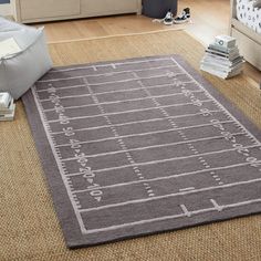 a large rug in the middle of a living room with a football field on it