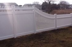 a white fence in the middle of a yard