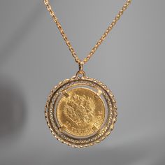 This pendant features a 1899 10 Roubles Russian Empire solid 14k yellow gold coin that displays Tsar Nicholas II in a 14k yellow gold setting. Materials: 14k yellow gold Pendant Size: 38.5mm from bottom of pendant to top of bail Comes with a 32 inch 14k yellow gold cable chain Tsar Nicholas II, the last Emperor of Russia, reigned from 1894 until his abduction in 1917. The coin of Nicholas II feature his portrait on the obverse, displaying his likeness in intricate detail. The reverse side showca Russian Necklace, Russian Coat, The Last Emperor, Empire Logo, Russian Jewelry, Last Emperor, Double Headed Eagle, Russian Revolution, Russian Empire