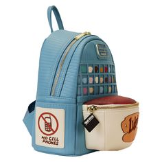 a blue backpack with no cell phones on it and a small purse next to it