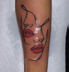 a woman's face with red lips on her leg