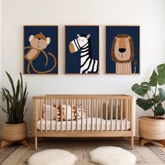 a baby's room with three pictures on the wall