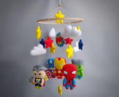 a mobile with various toys hanging from it's sides and stars on the ceiling