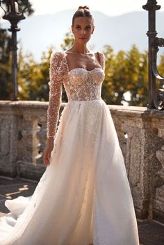 a woman in a wedding dress posing for the camera