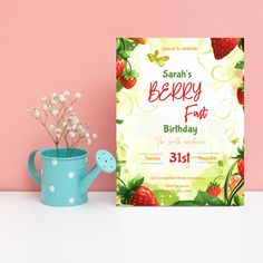 a birthday card with strawberries on it next to a watering can and flower pot