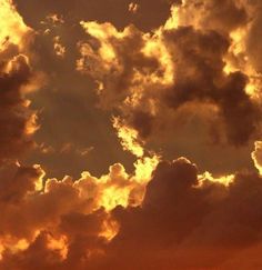 an airplane is flying in the sky at sunset