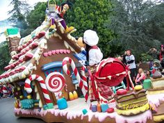 a large gingerbread house decorated with candy canes and candies for the holiday season