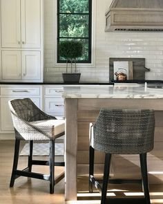 two chairs are sitting at the kitchen island