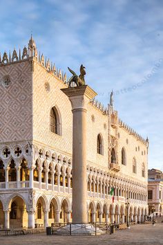 an ornate building with statues on the front and side walls in venice, italy at sunset