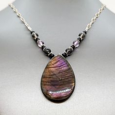 This is a particularly stunning Labradorite pendant. In the right light, it looks almost black and then burgundy purple. It's a gorgeous piece! So, I accented it with semiprecious gemstone beads and Hill Tribe Silver. I hung it on a beautiful Filigree chain at 21 1/2" with a 2" extender. Spiritually Connected, Agni Manitite, Right Light, Hill Tribe Silver, Strung Beads, Rare Stone, Labradorite Pendant, Semi Precious Gemstones, Clear Quartz