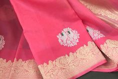 This is a beautiful handloom pure kora silk banarasi saree in a pleasant shade of bubblegum pink with kadwa sona rupa meenakari bird motifs in body, kadwa gold zari borders and sona rupa kadwa motifs in pallu. Saree comes with an unstitched blouse piece with motifs woven in kadwa technique. Falls, pico and tassels are done. Colour may vary slightly depending upon lighting. Handloom products may have some irregularities. All sales are final. Dry clean only. Pink Zari Weaved Tissue Silk Dupatta, Pink Chanderi Saree With Motifs, Pink Handloom Tissue Silk Saree, Pink Tissue Silk Saree With Zari Weaving, Pink Tissue Silk Handloom Saree, Pink Tissue Silk Blouse Piece With Zari Weaving, Pink Katan Silk Blouse Piece With Motifs, Pink Slub Silk Saree With Zari Work, Pink Chanderi Blouse Piece With Motifs