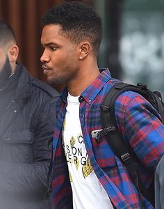 a man with a backpack is walking down the street