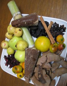 a white plate topped with lots of different types of fruits and vegtables