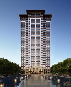 a tall building with lots of windows next to a pool in the middle of it