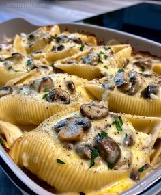 a casserole dish filled with shells and mushrooms