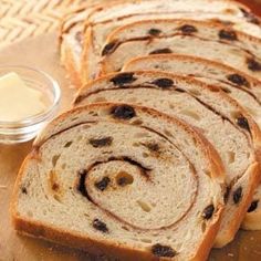 slices of bread with raisins and butter on a cutting board