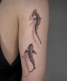 a woman's arm with two dolphins on it