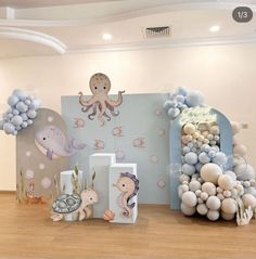 there are balloons and decorations on the floor in this room that is decorated with an octopus theme