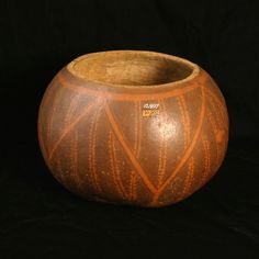 a wooden bowl sitting on top of a black surface