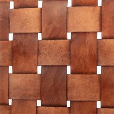 a close up view of a woven basket weave pattern made out of brown leather material