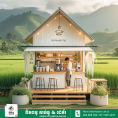 an advertisement for a coffee shop in the middle of a rice field with mountains in the background