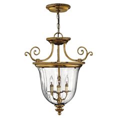 an antique brass chandelier with clear glass shades and gold trim, hanging from the ceiling