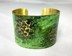 These unique, hand-formed copper and brass cuff bracelets with vibrant patinas create stunning accents to your personal style. Dress up or down- either way you'll be wearing an adornment that will turn heads, start conversations, and delight the eye of the beholder. This is a customizable hammered brass cuff with a gorgeous Tiffany or Light Green patina. Order yours in your favorite color, width and size (length). Tiffany tends to have marbled blues/teal and a little lighter green, whereas Green Artisan Green Cuff Bangle Bracelet, Adjustable Gold Cuff Bracelet With Patina, Unique Green Cuff Bracelet Bangle, Unique Green Cuff Bangle Bracelet, Unique Green Bangle Cuff Bracelet, Unique Green Metal Cuff Bracelet, Handmade Green Metal Cuff Bracelet, Green Handmade Metal Cuff Bracelet, Unique Brass Cuff Bracelet