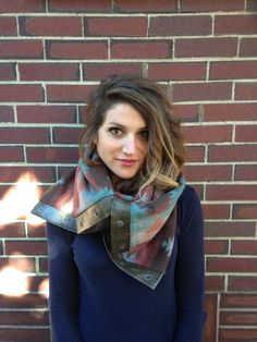 a woman standing in front of a brick wall