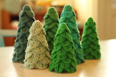 small christmas trees sitting on top of a table