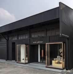 an empty store front with several pieces of furniture in the windows and on the ground