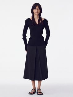 The Inverted Pleat Skirt is a beautifully tailored piece that showcases classic design with a modern twist. It features a high-waisted fit that accentuates the waistline, while the inverted pleats create a graceful, flowing movement. - This skirt is designed with a structured waistband to provide support and a seamless silhouette.- The inverted pleat detail not only adds an element of sophistication but also allows for a greater range of motion.- It's a versatile item that can be dressed up for formal occasions or paired down for a day at the office.- Meticulously stitched, the skirt holds its shape throughout the day, making it both stylish and practical for continuous wear. Chic Asymmetrical Pleated Skirt For Formal Occasions, Chic Formal Asymmetrical Pleated Skirt, Chic Fitted Skirt With Pleated Hem, Office Fitted Asymmetrical Pleated Skirt, Formal Asymmetrical Pleated Skirt With Lining, Elegant Asymmetrical Pleated Skirt For Office, Modern Midi Skirt For Evening, Elegant Fitted Pleated Skirt For Fall, Elegant Fitted Pleated Skirt For Night Out