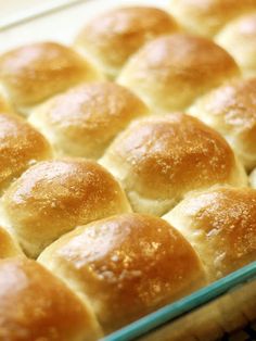 a baking pan filled with rolls on top of a table