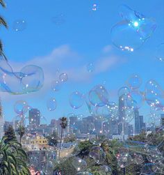 many soap bubbles are floating in the air over a cityscape and palm trees