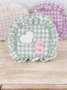 a green and white checkered table cloth with a pink number six on the front