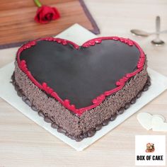 a heart shaped cake sitting on top of a white plate